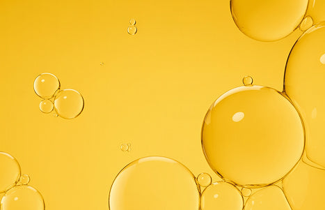 Niacinamide droplets suspended in golden oil